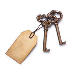 Concept of new life, dream or house with vintage keys and mockup empty paper tag