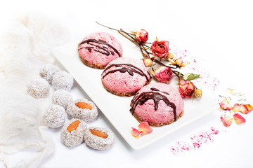 Cashew souffle cakes with beetroot powder on a pillow of crushed nuts and dried figs. Vegan, dietary raw sweets.