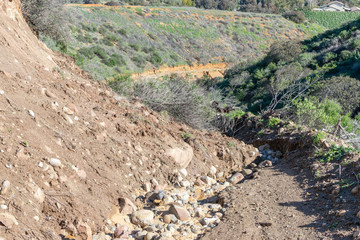 damaged mountain dirt road from recent rain storms