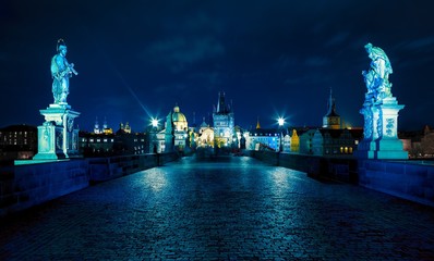 Fototapeta premium Prague. Famous Charles Bridge to the Old Town tower and St. Francis of Assisi Church (UNESCO). Czech republic, Europe. Blue night or evening.
