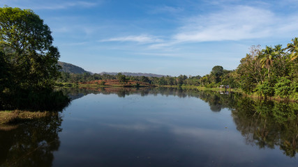 Fototapeta na wymiar Reflections in the Periyar River. Thattekad, Kerala, India