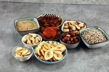 dried fruits and assorted nuts composition on rustic table