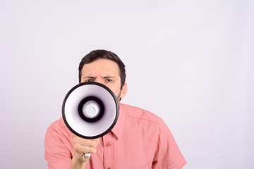 Young man screaming on a megaphone.