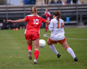 High School girl athletes making amazing plays during a soccer game © Joe