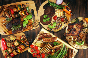 Assorted delicious grilled meat with vegetable on rustic table