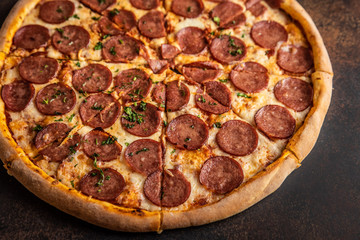 Pizza pepperoni on wooden table close up