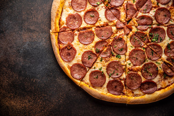 Pizza pepperoni on wooden table close up