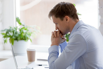 Focused businessman sitting in office working and thinking 