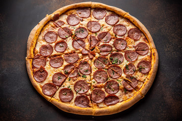 Pizza pepperoni on wooden table close up
