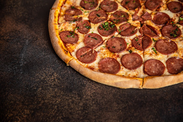 Pizza pepperoni on wooden table close up