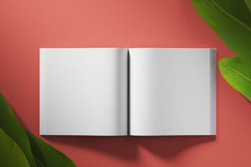 Empty white book unfolded on red background with tropical flowers. Top view. Mock up. 3d rendering