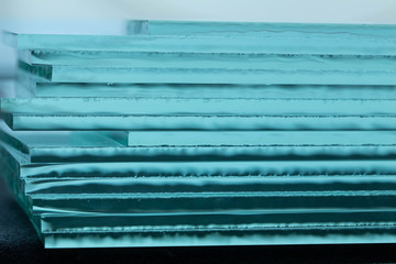 Pieces of transparent glass stacked on each other and creating reflections
