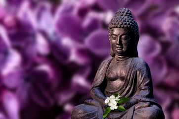 Buddha statue holds apple tree flower in the hands. Religious theme template.