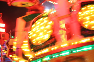 disco lights synthwave neon fairground ride night lights funfair amusement park moving, light trails, slow shutter-speed long exposure illuminations futuristic sci fi 