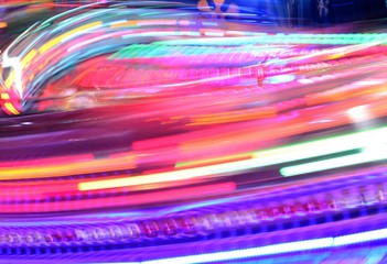 disco lights synthwave neon fairground ride night lights funfair amusement park moving, light trails, slow shutter-speed long exposure illuminations futuristic sci fi 
