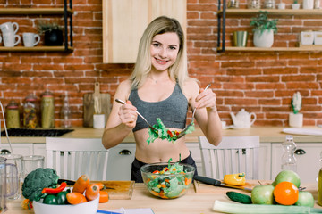 Smiling young housewife mixing fresh salad . Healthy Lifestyle And Eating. Diet. Dieting Concept. Healthy Food. Wellbeing, Wellness.