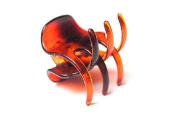 closeup of brown plastic hair clip on white background