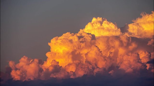 Sunset fluffy clouds time lapse background. UHD 4K