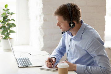 Businessman sitting at workplace improve knowledge using online lessons 