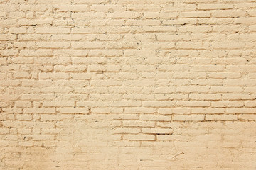 Old brick wall with beige paint background texture