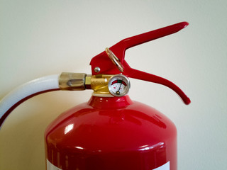 top of a fire extinguisher hanging on the wall