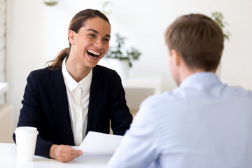 Cheerful biracial HR manager interviewing job candidate
