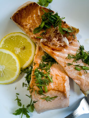 roasted salmon with herbs on a plate