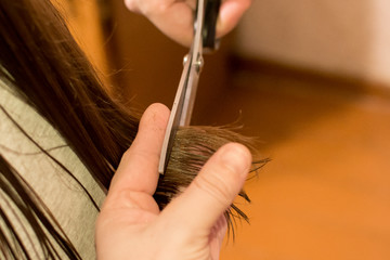 Haircut at home. Concept: hair care, savings in a hairdressing salon, haircut for children at home.