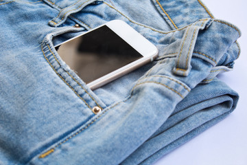 Headphones and smartphone in the pocket of jeans. Smart phone in the pocket jeans.