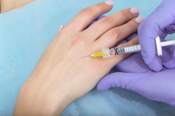 Injection hand rejuvenation closeup. concept of aesthetic medicine.