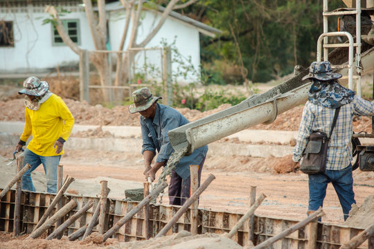 NAKHON PHANOM, THAILAND - DEC 24, 2018 : Concrete mixer truck. Workers are pouring concrete in site building construction