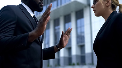 Afro-american businessman apologizing to female boss for poor quality work