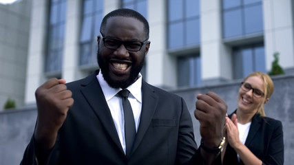 Cheerful businessman celebrating contract signing, expressing happiness emotion