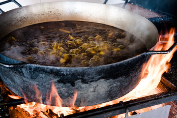steaming stew on open fire