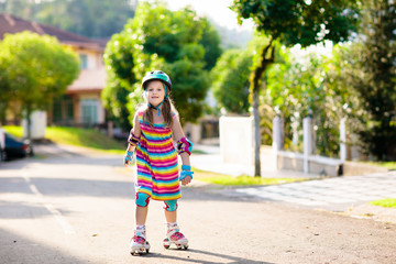 Child on inline skates. Kids skate roller blades.