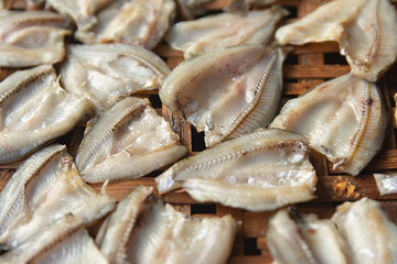 Dried fish on Bamboo sieve with sunny