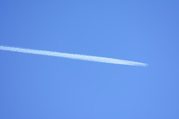 inversion trace from the passenger liner at big height against the background of the clear blue sky