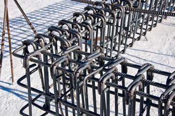 Billets of reinforcement at the construction site. Construction of the building with the help of reinforced concrete. Reinforcement of concrete base.