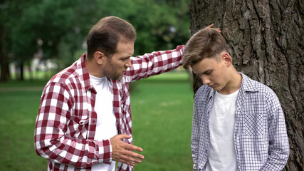 Strict dad scolding son for bad marks at school, parent respect, upbringing - Powered by Adobe