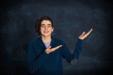 portrait of smiling teenager pointing