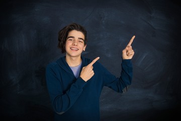 portrait of smiling teenager pointing