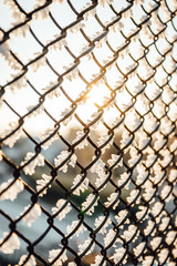 Chain link fence with barbed wire, background texture. 