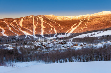 Looking down at the ski lodge and hotel with Mt. Mansfield looming behind, Stowe, Vermont, USA