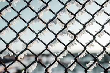 Chain link fence with barbed wire, background texture. 