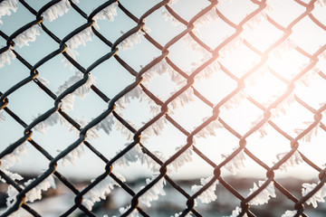 Chain link fence with barbed wire, background texture. 