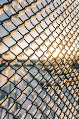 Chain link fence with barbed wire, background texture. 