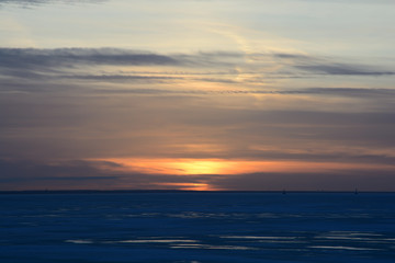 sunset over the frozen Gulf of Finland