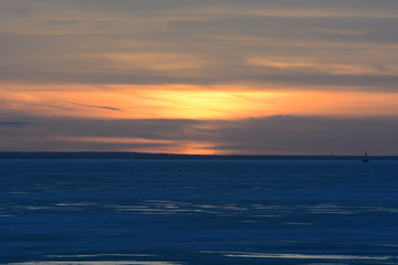 Naklejka na ściany i meble sunset over the frozen Gulf of Finland