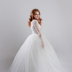 Fototapeta na wymiar Happy young woman bride in a lavish wedding dress.