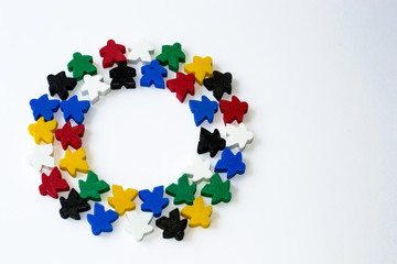 Groups of colorful meeples in circle isolated on gray background. Colorful round frame of game...